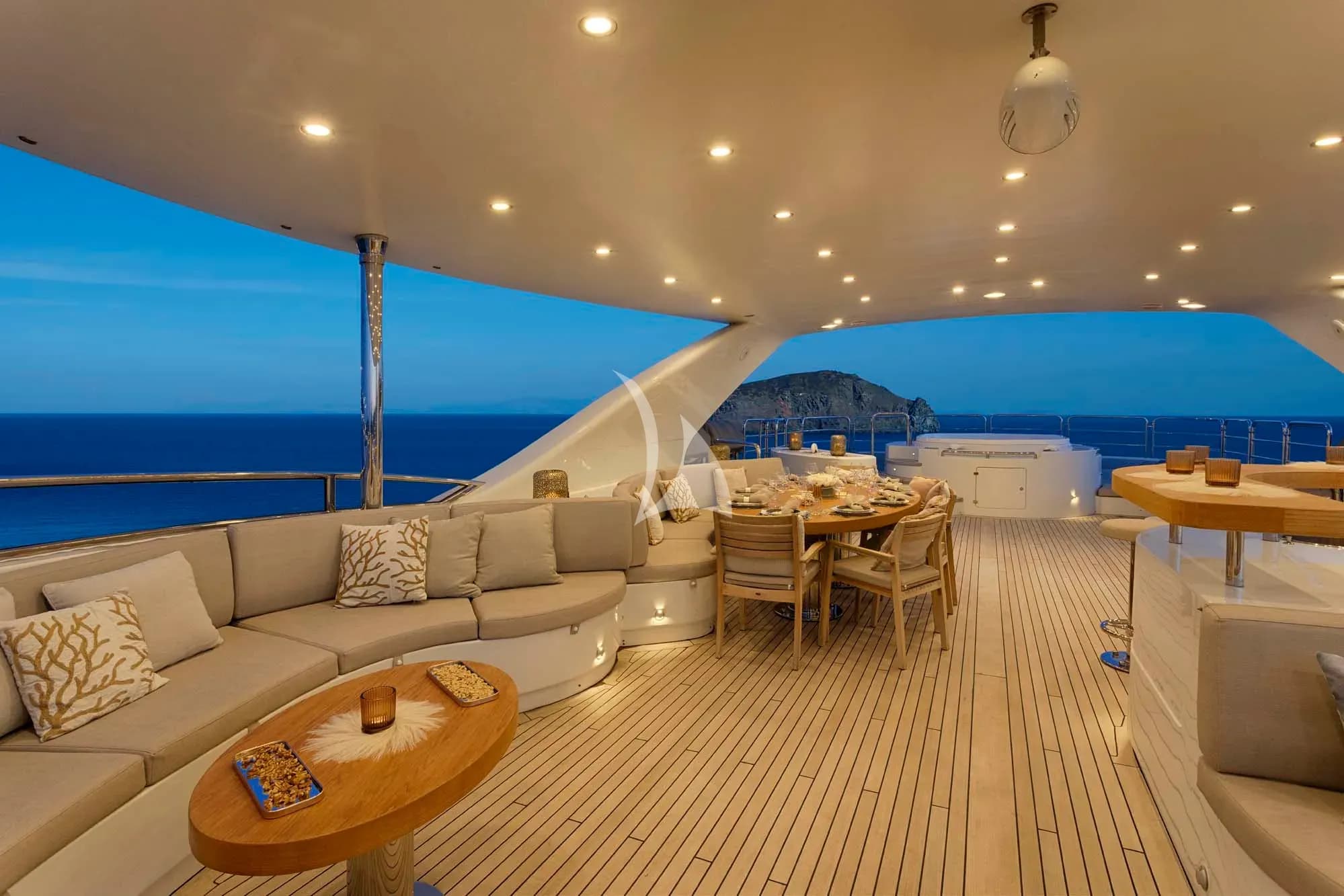 The exceptionally spacious unobstructed  sundeck has a Jacuzzi, a dining table, a bar & various spacious lounges & sunbathing areas