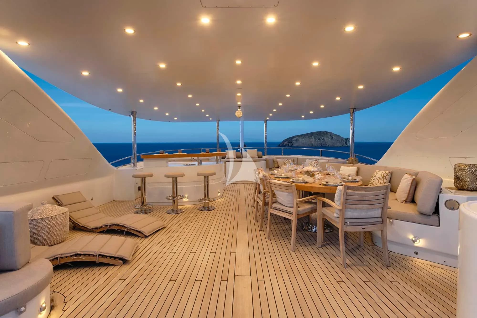The exceptionally spacious unobstructed  sundeck has a Jacuzzi, a dining table, a bar & various spacious lounges & sunbathing areas